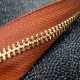 Fermeture YKK métal fauve et or*